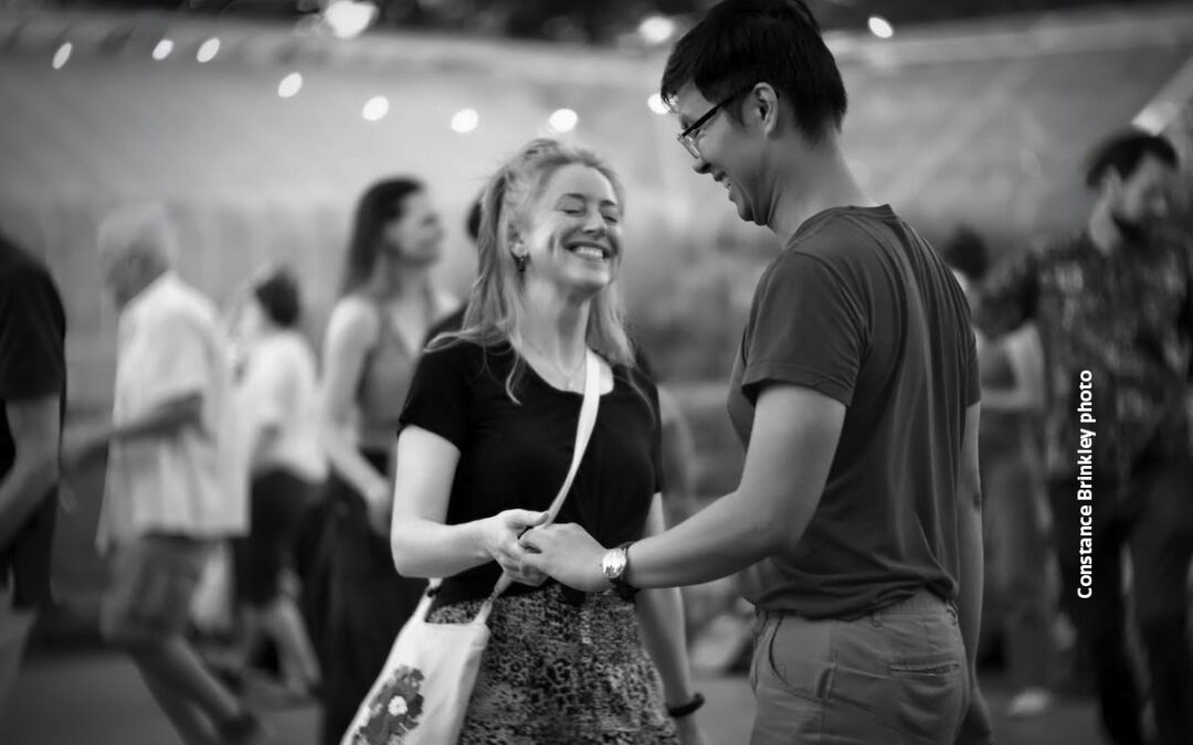 Partner dancers smiling at Dancing til Dusk event, Constance Brinkley photo